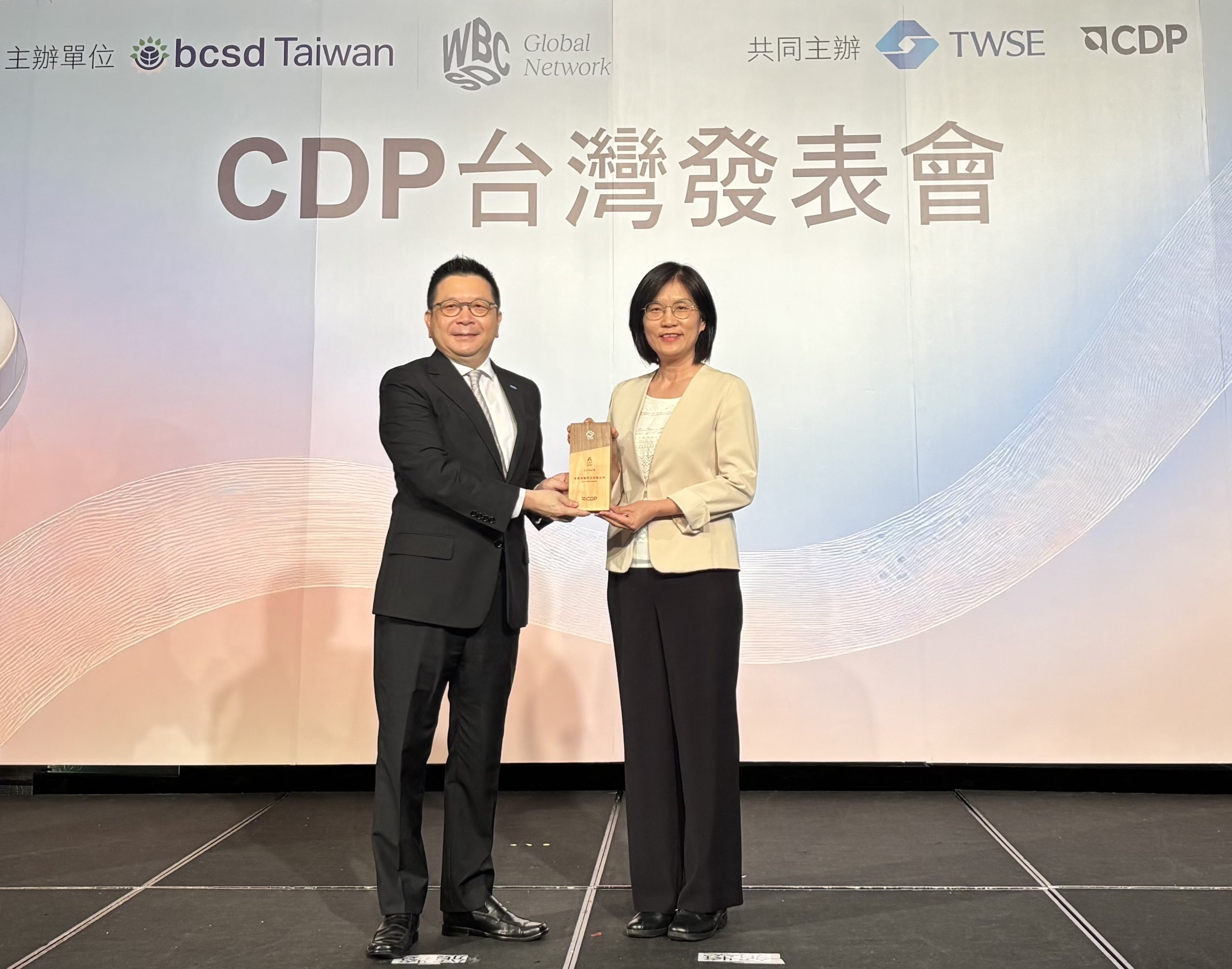 友達永續成果再獲國際評比肯定，獲頒CDP氣候與水資源雙項領導力評級。今由臺灣證券交易所董事長林修銘（左）頒獎，友達光電永續長古秀華（右）代表受獎